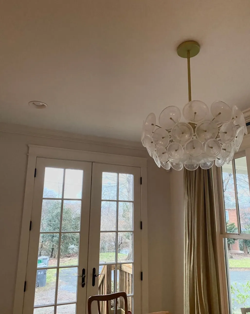 Bright dining room with French doors and a chandelier