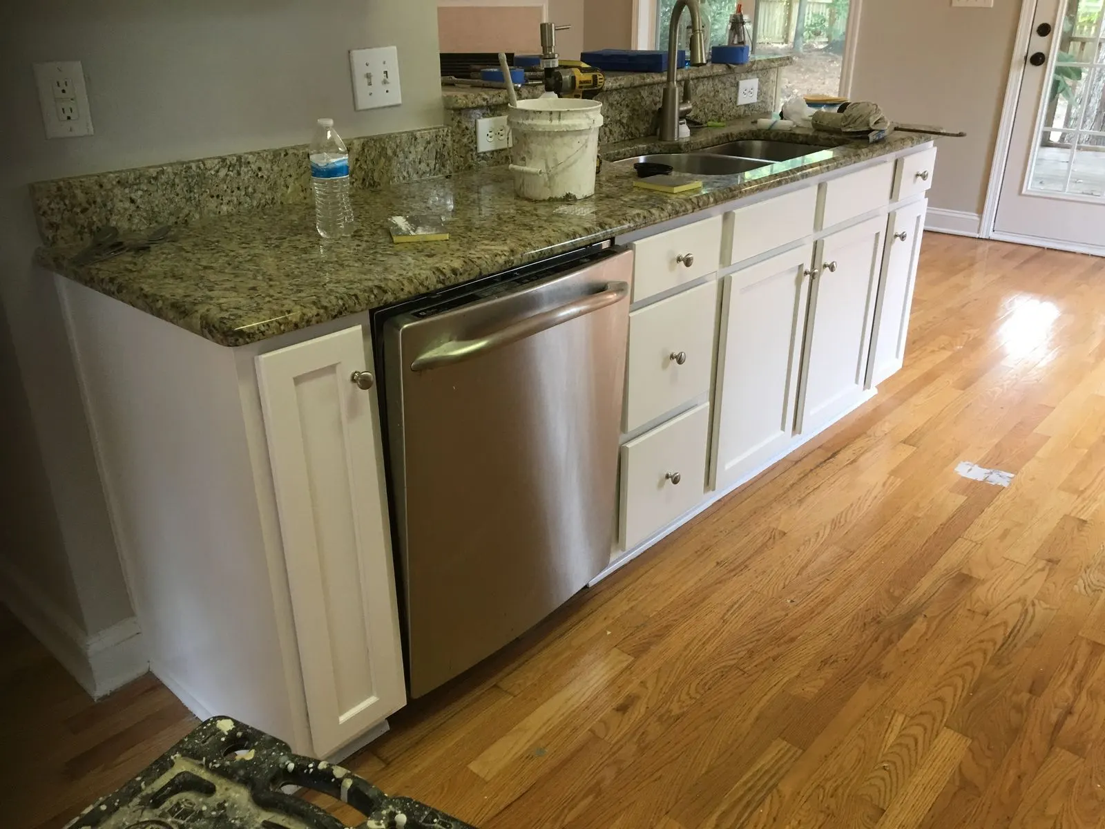 The same kitchen island with the cabinets painted white