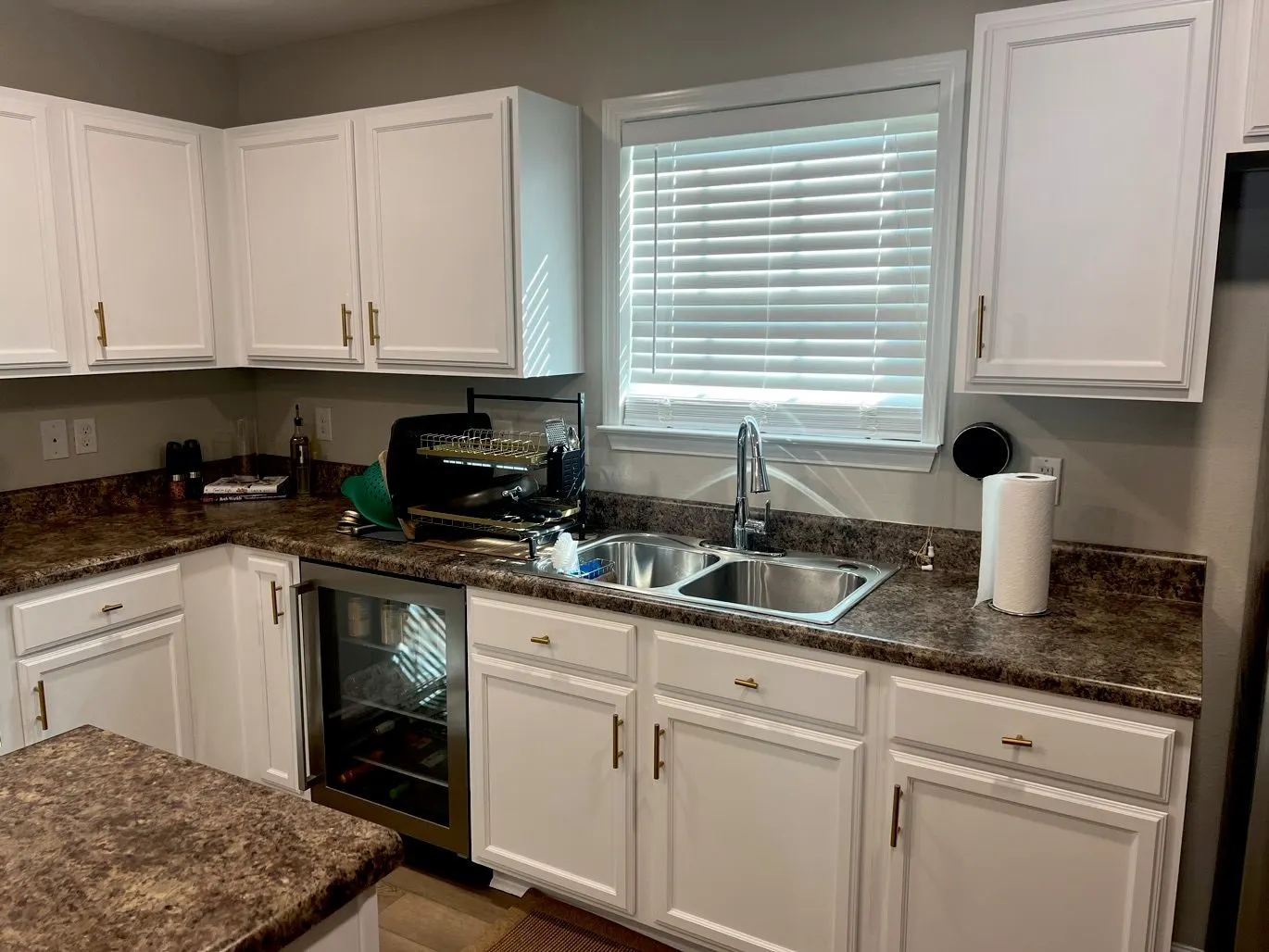 White painted kitchen cabinets along the sink wall