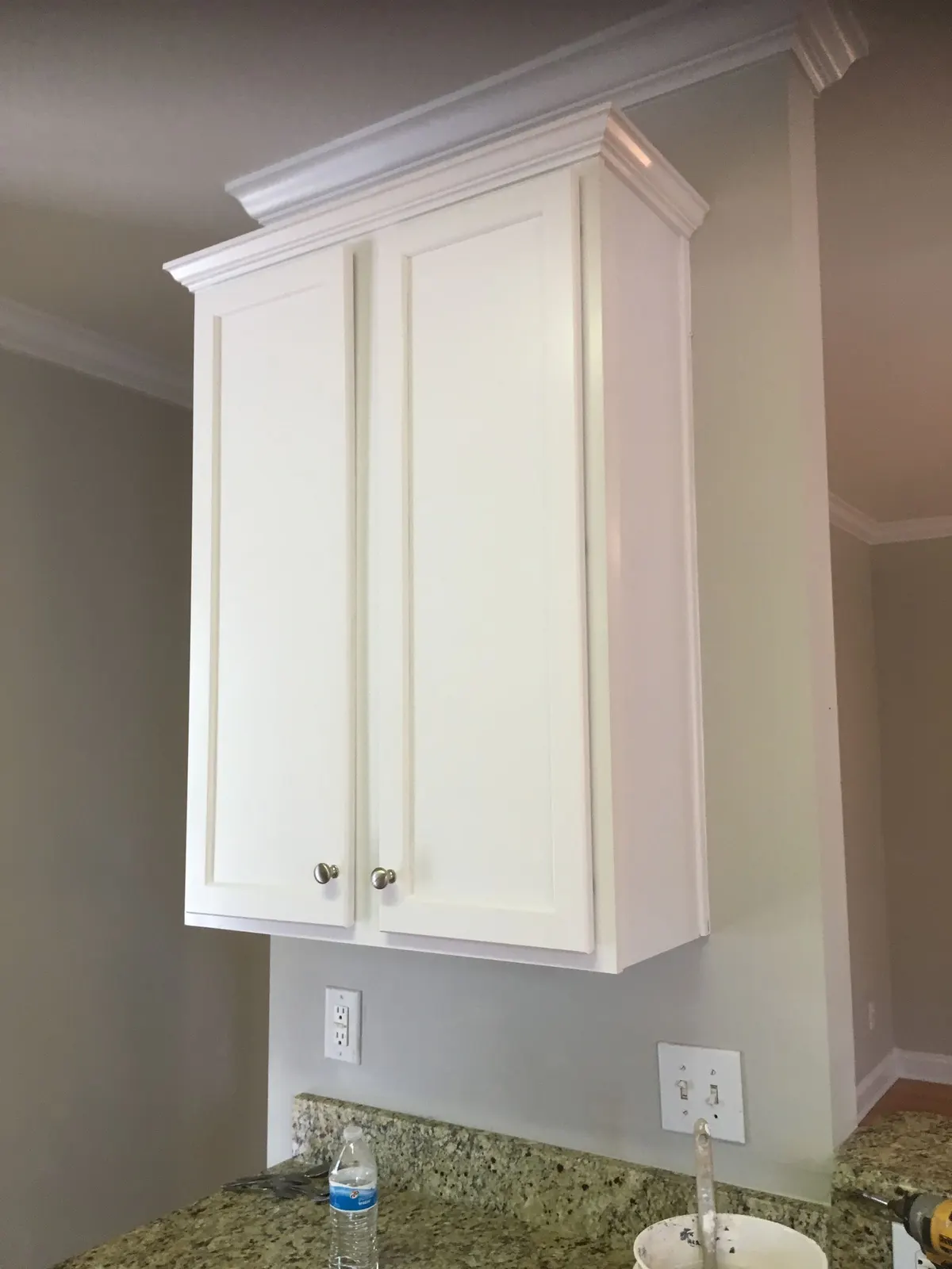 Upper kitchen cabinet painted white
